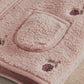 Pink fleece gilet close-up of embroidered chest pocket and textured trim