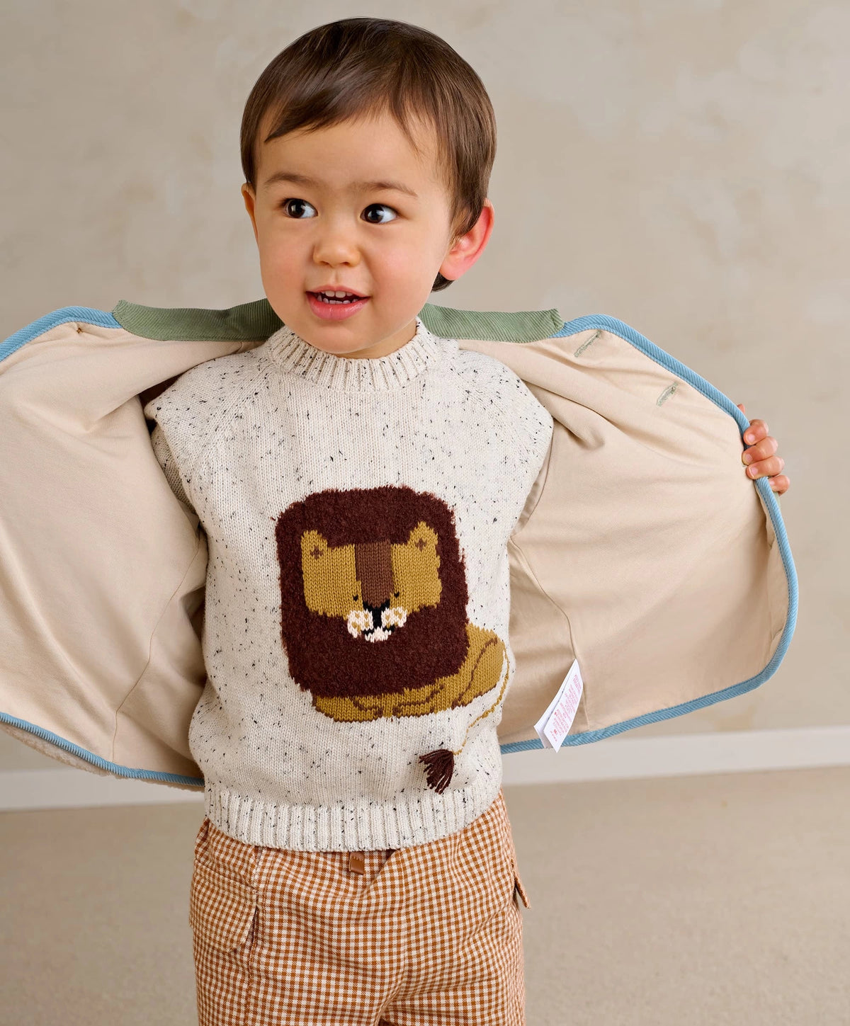 Children's lion knit jumper, cream speckled with front lion patch; raglan sleeves