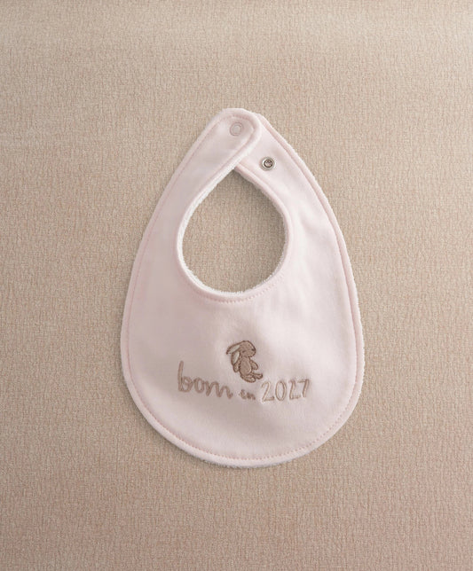 Pink baby bib with snap at neck opening and embroidered bear 'born in 2027'