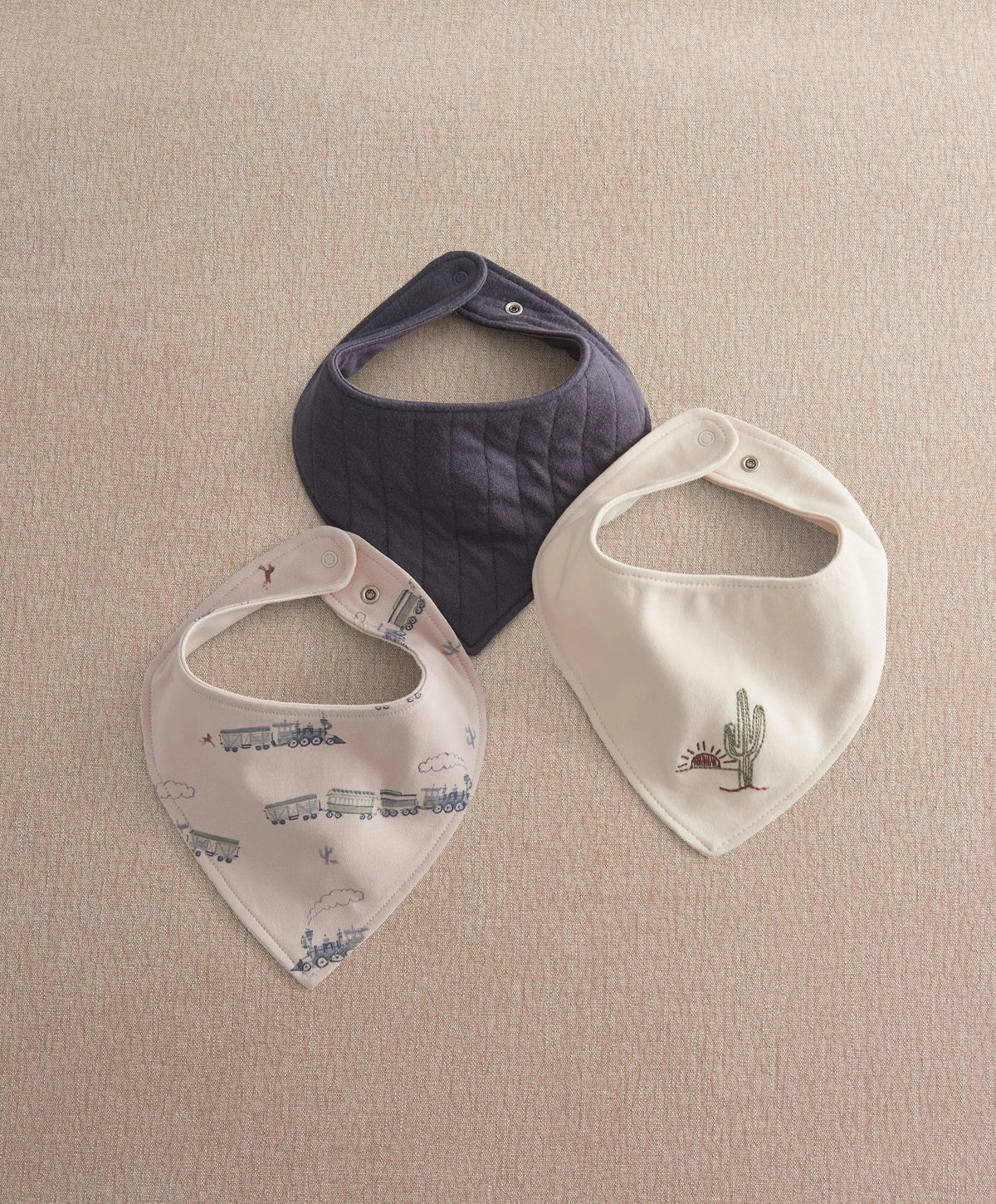 Bandana bib pack: navy, white cactus, and light train prints