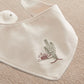 White bandana bib with green cactus embroidery and snap closure