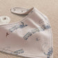 Blue bandana bib with train and cloud print, snap closure