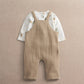 Baby dungaree and bodysuit set: tan ribbed overalls over white acorn-print sleeves