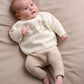 Cream knit 2-piece baby set with long-sleeve top and pants, 'hello world' embroidery.