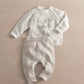 Cream knit 2-piece baby set with long-sleeve top and pants, 'hello world' and 'Aubrey' text.