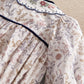 Floral romper bodice with scalloped navy-trim collar and pintuck yoke