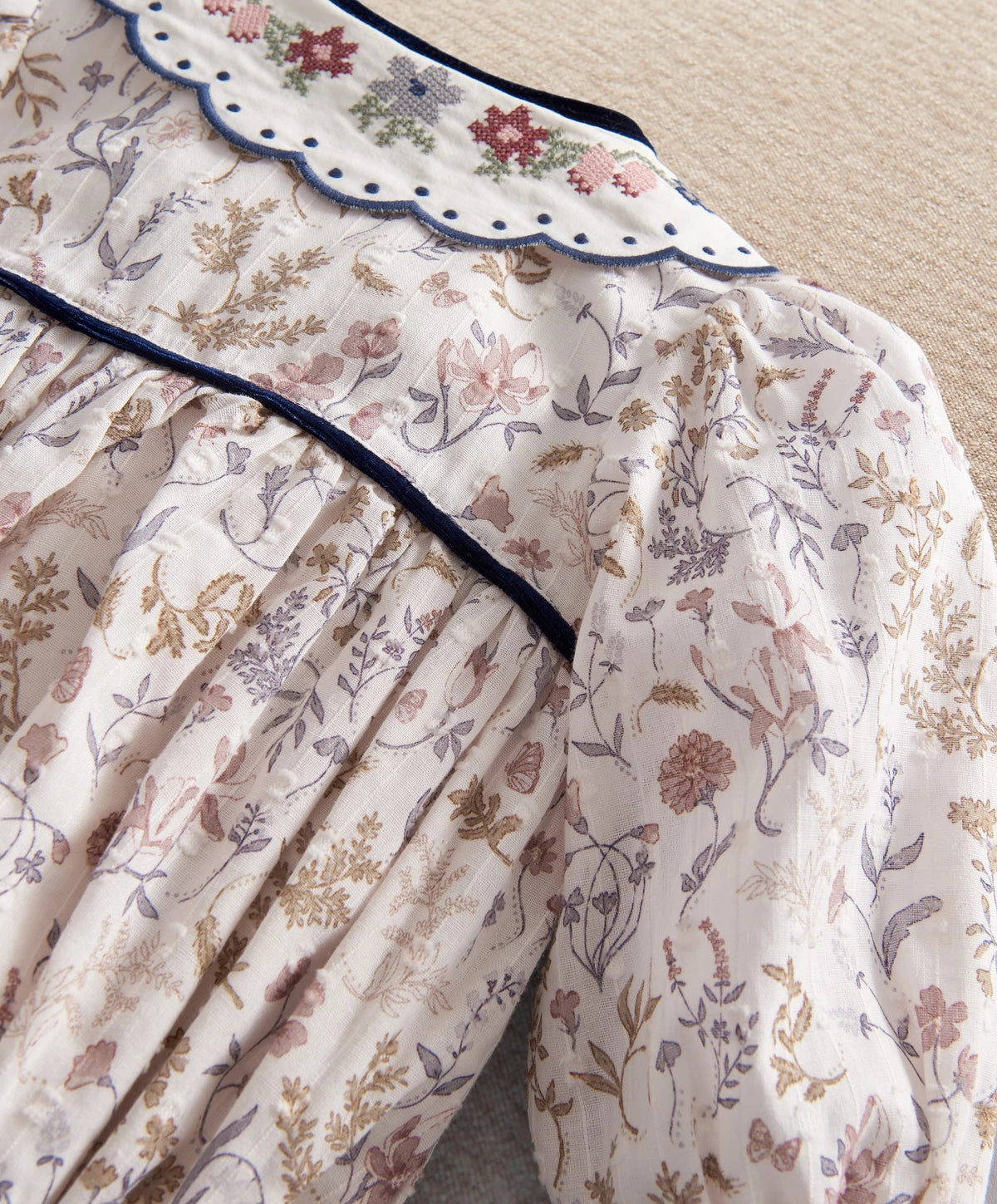Floral romper bodice with scalloped navy-trim collar and pintuck yoke