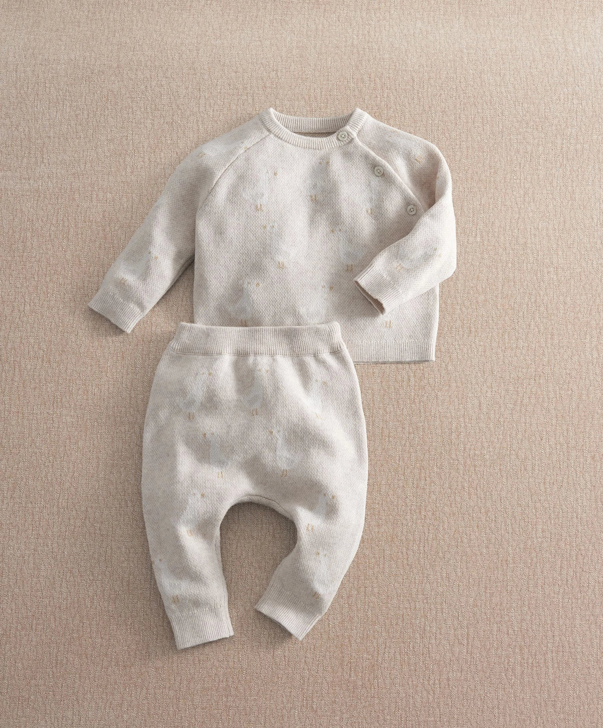 Cream duck-knit 2-piece set with speckle pattern: long-sleeve top and cuffed pants.
