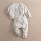 Cream duck-knit 2-piece set, speckle pattern: long-sleeve top with matching cuffed pants.