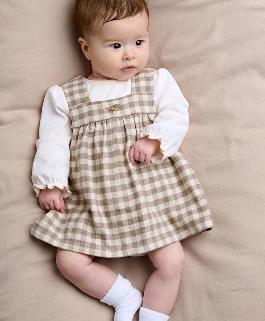 Toddler gingham dress over long-sleeve white bodysuit, tan and cream check with green detail