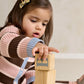 Child wearing striped cardigan and knitted wide-leg trousers set, pink and brown stripes