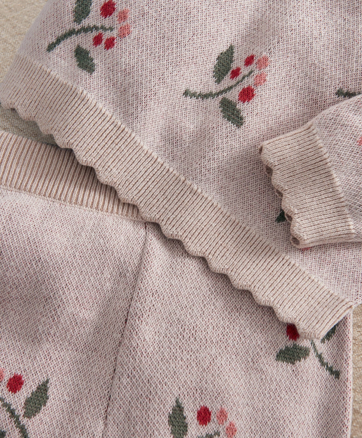 Light pink knitted sleeve hem and cuff with berry and leaf print