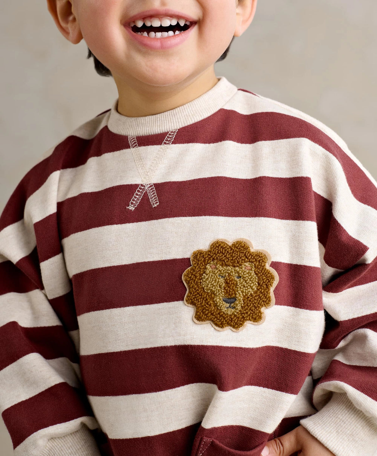 Striped romper with lion patch and front button placket, burgundy and cream