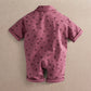 Purple floral short-sleeve romper, back view with collar and cuffed legs