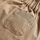 Tan trouser pocket and stitched seam detail on elastic waist