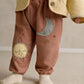 Applique trousers with cuffs and elastic ankle, sun applique on leg, dusty rose