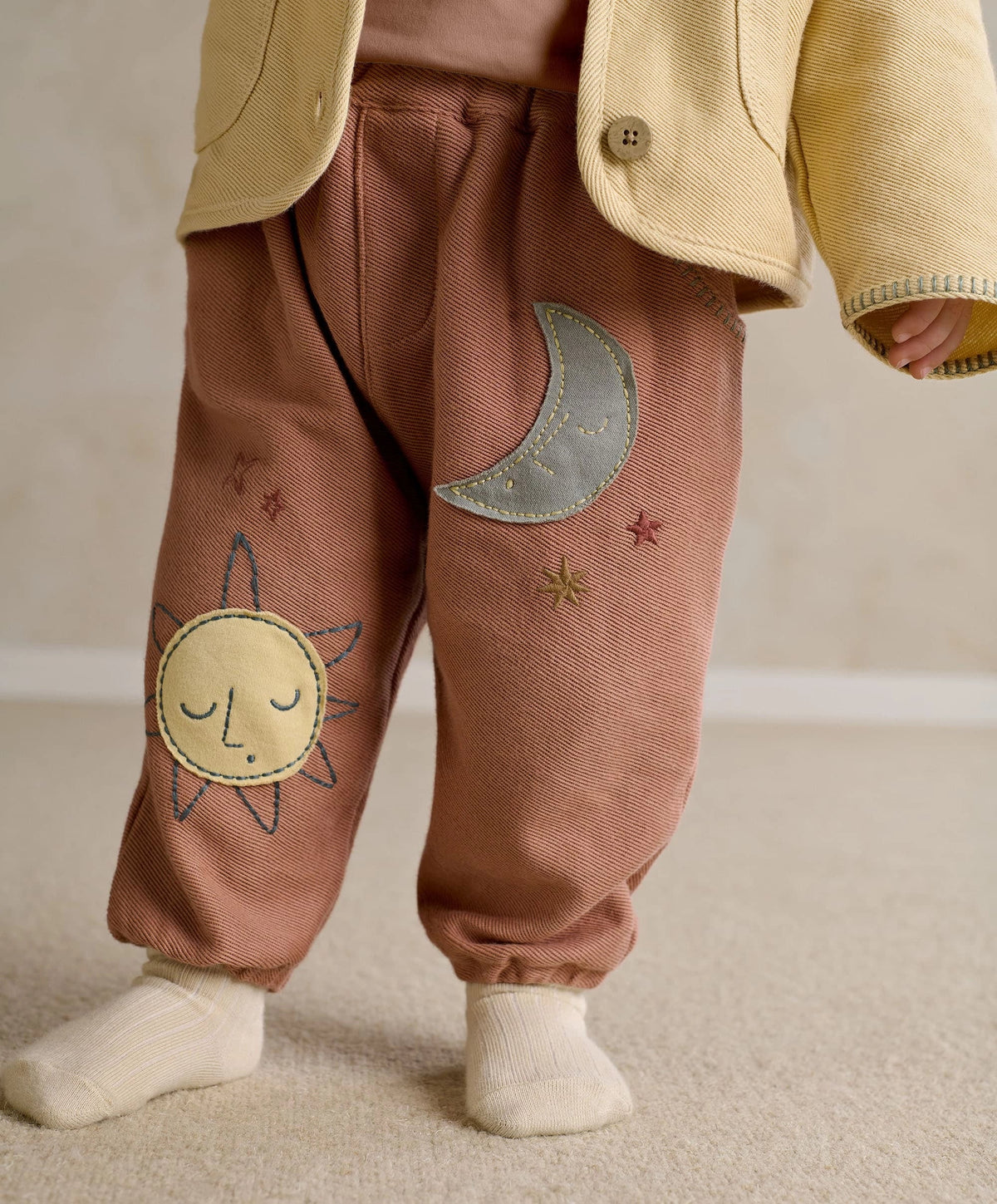 Applique trousers with cuffs and elastic ankle, sun applique on leg, dusty rose