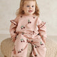 Pink bramble berry printed joggers on a toddler with elastic cuffs