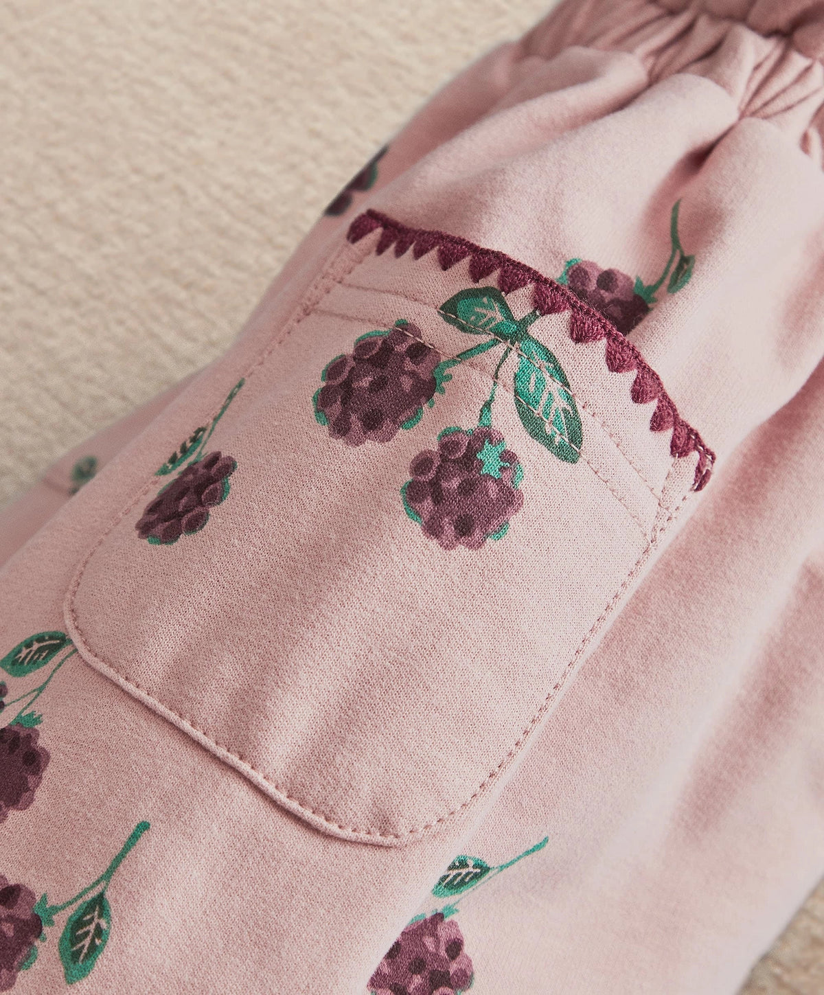 Pink joggers with side pocket and stitched bramble berry graphic