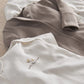 Gray ribbed button-top and white embroidered bodysuit from baby clothing set