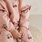 Light pink toddler sweatshirt with berry-and-leaf print and ruffled cuff