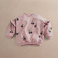 Light pink kids sweatshirt with berry print, round neck, ruffled sleeves