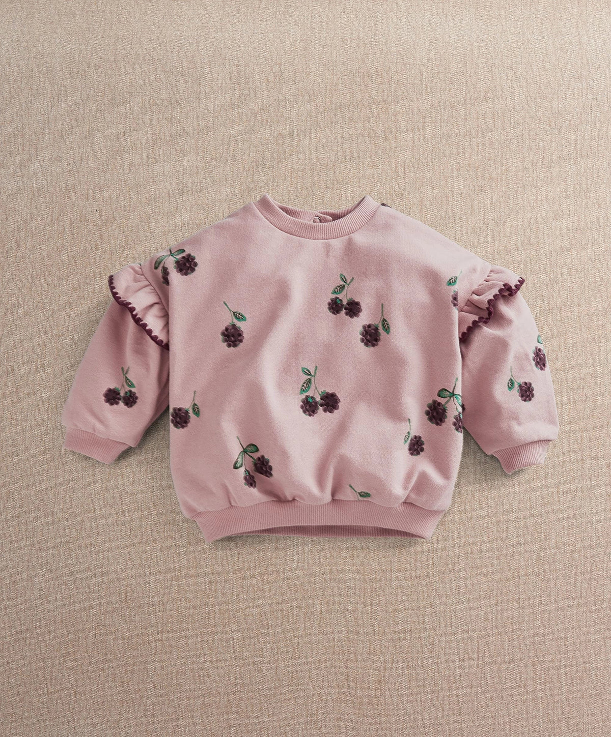 Light pink kids sweatshirt with berry print, round neck, ruffled sleeves