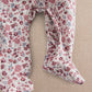 Ditsy floral baby romper with open back and rounded leg openings