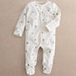 White clover-print long-sleeve baby romper with snaps and footed bottoms