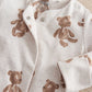 White bear print all-in-one with long sleeves, button front, and bear-pattern cuffs.