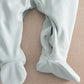 Light blue baby sleepsuit showing foot opening with snap buttons