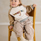 Raglan sweatshirt on child: speckled front with 'imagine' print, beige sleeves, gray cuffs
