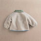 Cream borg jacket back view with mint collar and blue hem trim
