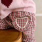Red gingham trousers with heart pocket trim and ruffled leg cuff detail