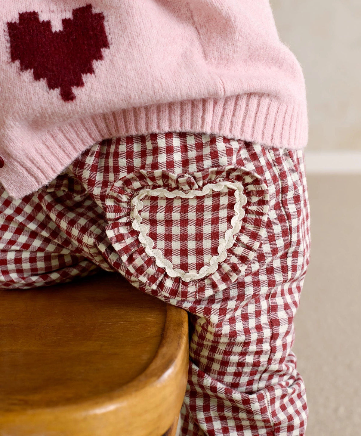 Red gingham trousers with heart pocket trim and ruffled leg cuff detail