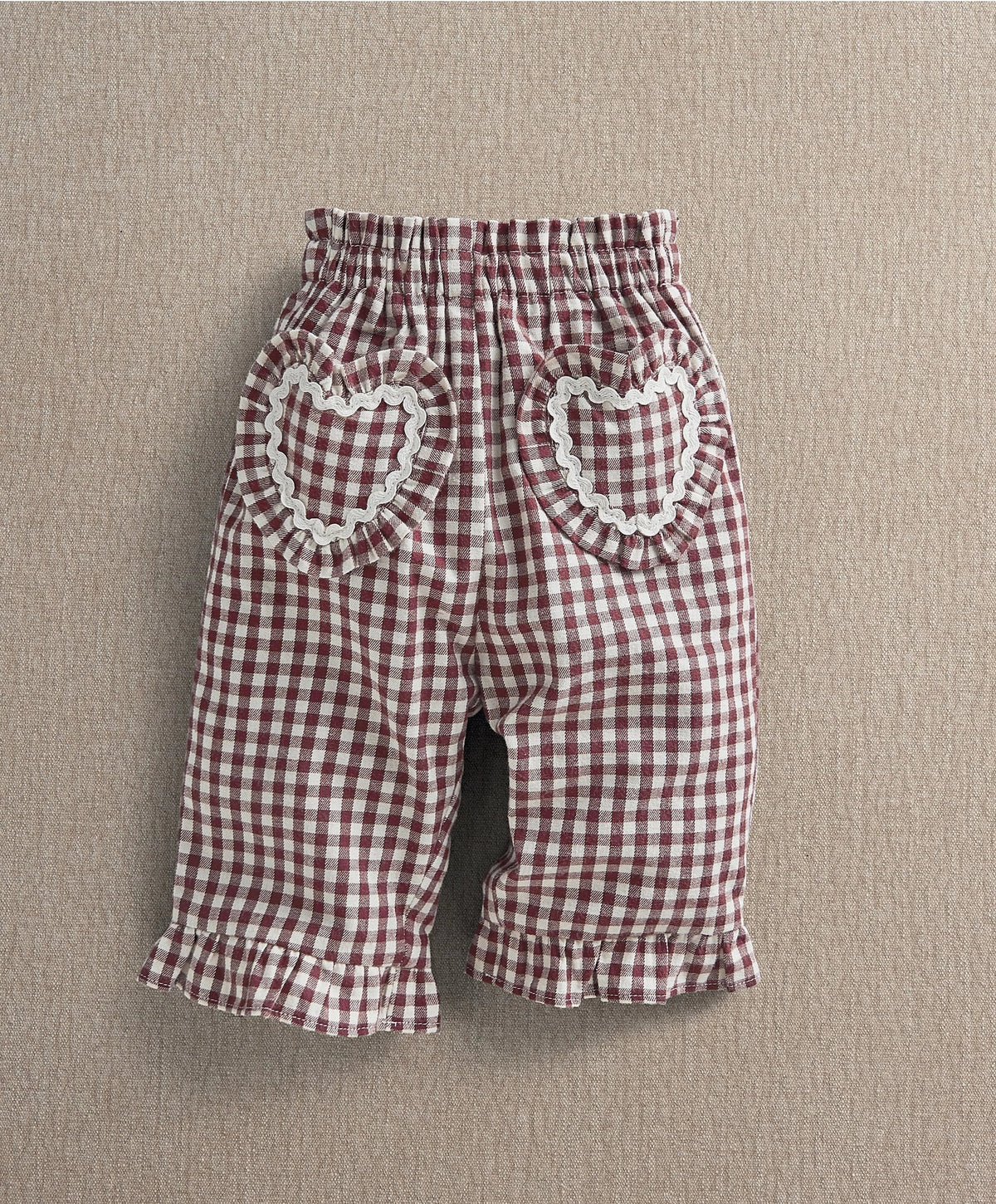 Red gingham trousers with heart patch pockets and ruffled hems