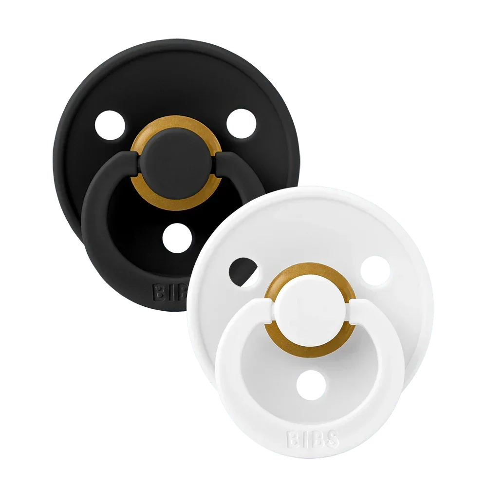 Two latex pacifiers, black and white shields with gold ring, size 2 (6–18 m)