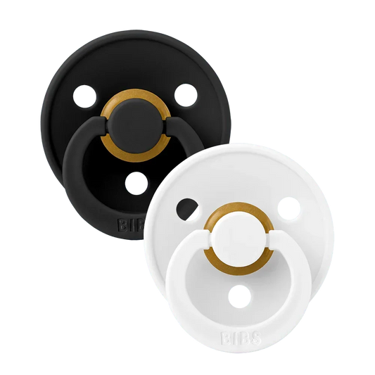 Two latex pacifiers, black and white shields with gold ring, size 2 (6–18 m)