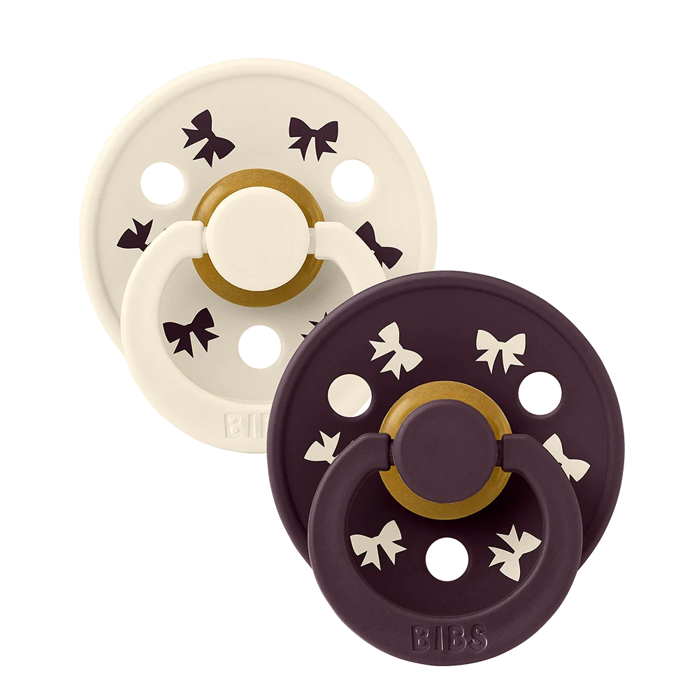 2-pack latex pacifiers, ivory and plum with star accents and shield base
