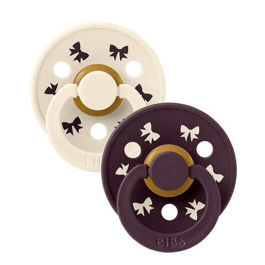 2-pack latex pacifiers, ivory and plum with star accents and shield base