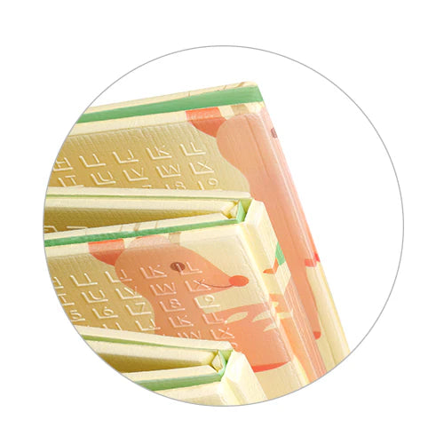 Foam play mat corner close-up with folded layers and colorful road pattern.