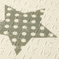 Foam play mat surface detail with raised dots and bars, pale cream with dark gray.