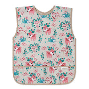 Sleeveless kids apron with pink, teal forest animal print and beige trim; front bib
