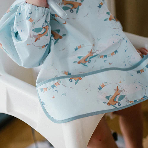 Light blue long-sleeve baby bib with gray-edged drape and airplane print