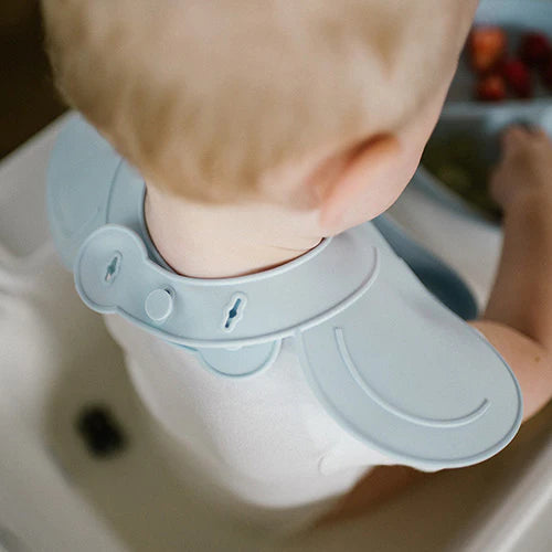 Blue silicone bib neck lock close-up with adjustable strap and collar