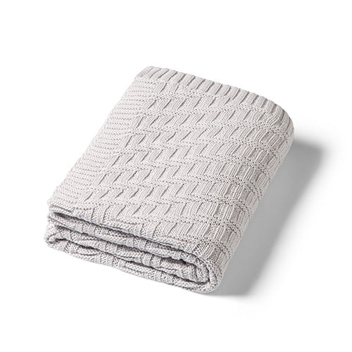 Grey cotton knitted blanket with textured chevron stitch, neatly folded