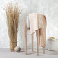 Merino wool blanket, light beige cable-knit throw draped over chair