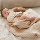 Merino wool blanket, light beige cable-knit blanket on sofa with baby