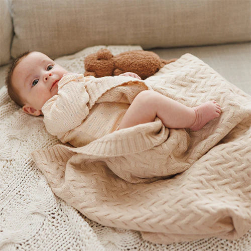 Merino wool blanket, light beige cable-knit blanket on sofa with baby