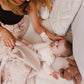 Merino wool blanket, light beige knit spread as toddler rests